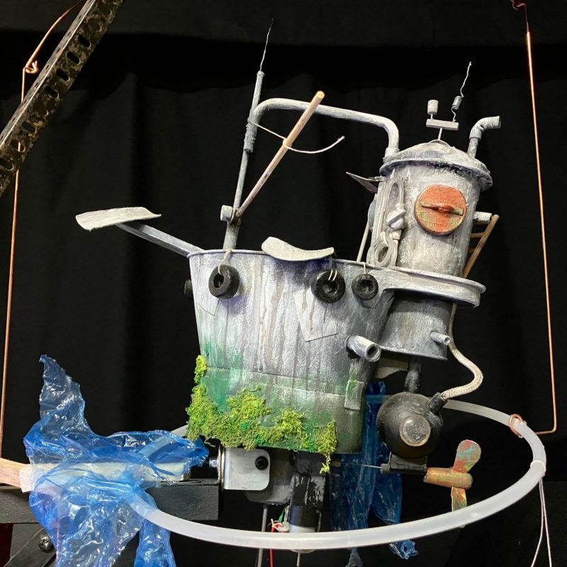 Image of motorised puppet made from buckets and pipes