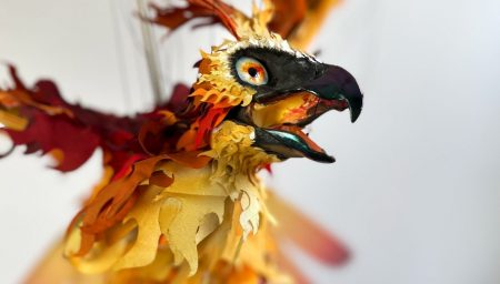 GPT An intricately crafted marionette of a phoenix with a vivid array of fiery feathers in mid-flight, suspended by strings.