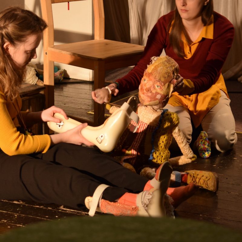 Two puppeteers operating a puppet with Cerebral Palsy