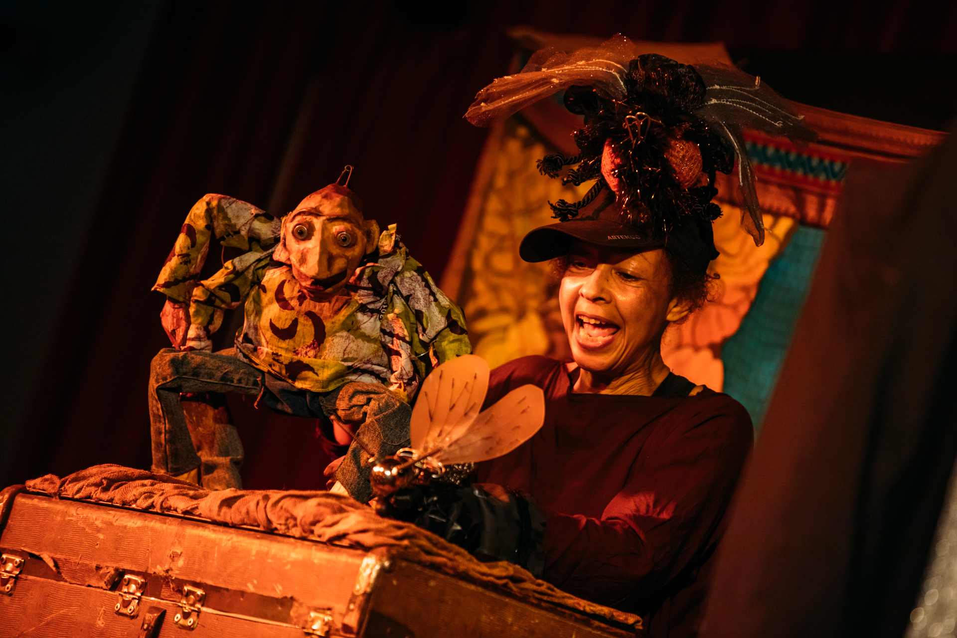 Puppeteer with two Anansi puppets